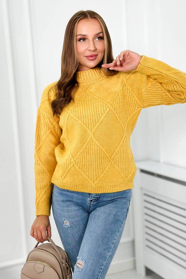 Kesi Diamond mustard sweater draped over the head