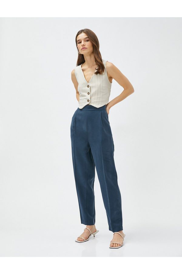 Koton Koton Silky-textured pants with elastic waist and pockets.
