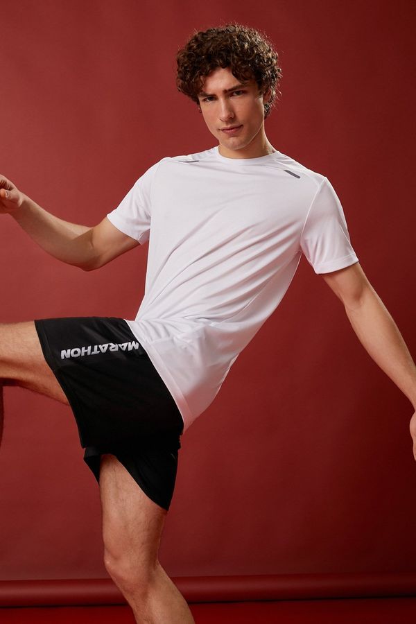 Koton Koton Sports Shorts The waist is laced, pockets, slogan printed, breathable fabric.