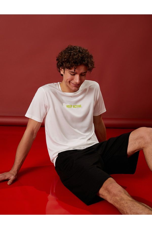 Koton Koton Sports T-shirt with the slogan Printed Crew Neck Short Sleeved Breathable Fabric.