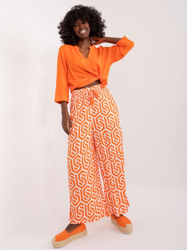 Fashionhunters Orange wide trousers with SUBLEVEL print